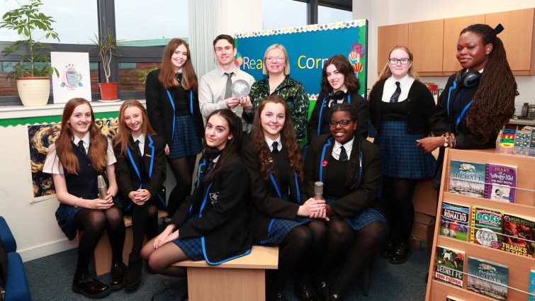 This image shows a group of Holy Cross high school pupils with Councillor Lynsey Hamilton and teacher Peter Kelly after their podcast won a top award