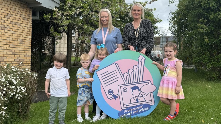 This image shows staff and pupils from Calderside Nursery with a Community Wish List prop