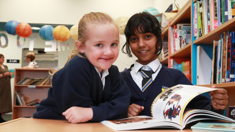 Canberra primary pupils enjoying the school's reading buddies initiative