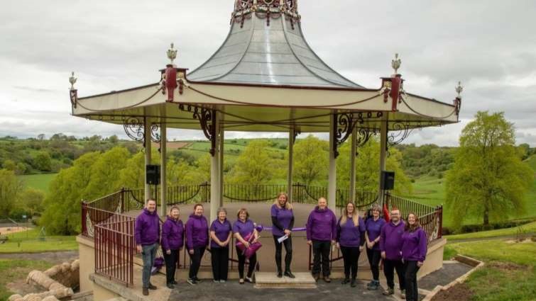 This image is a group shot of the Friends of Stonehouse Park at the bandstand in the park