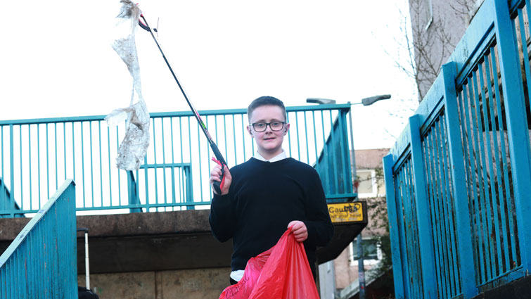 pupil with bag full of litter