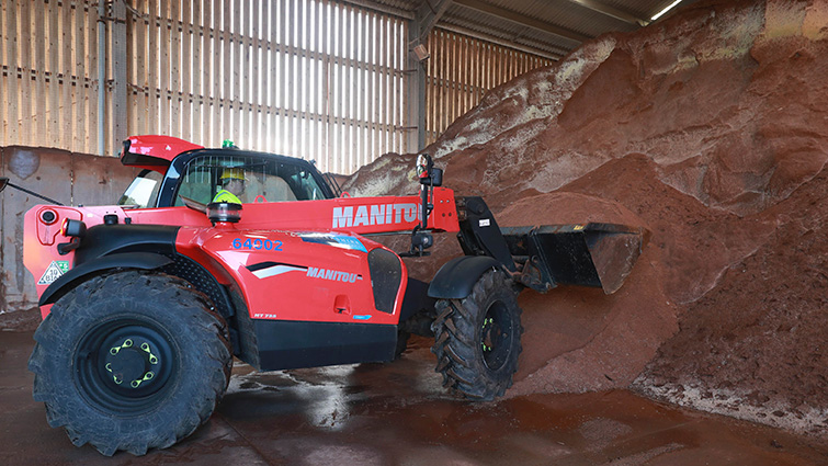 This is a photo of a tractor moving grit stocks from the salt barn at Canderside Roads depot. 