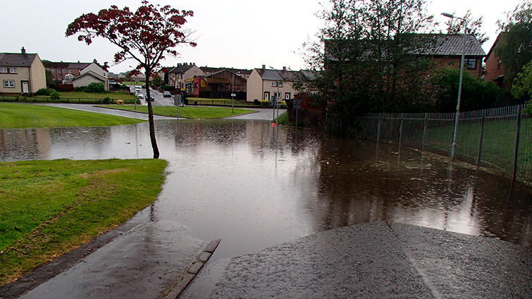 This shows a road which has been flooded in a residential area of South Lanarkshire during a recent storm. 