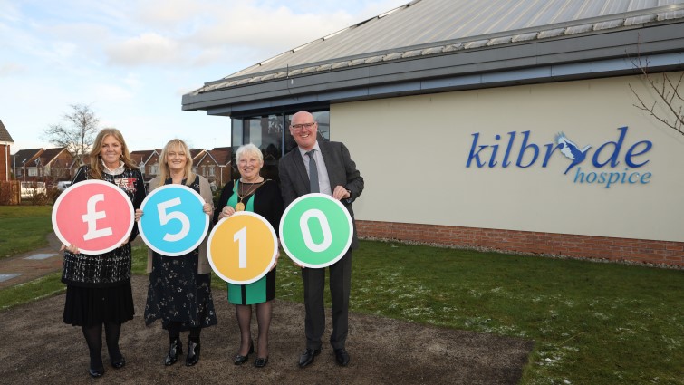 This image shows the Provost and others holding the numbers 510 after Education Resources raised money for the Provost's Touch a Life Make a Difference charity initiative