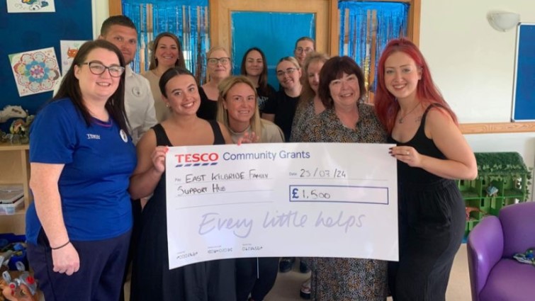 Team members at East Kilbride Family Support Hub and Tesco representatives with a donation from the local supermarket.